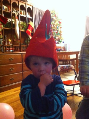 Zion in an elf hat at a birthday party