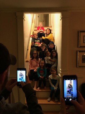 the boys and their cousins sitting on the stairs for a picture