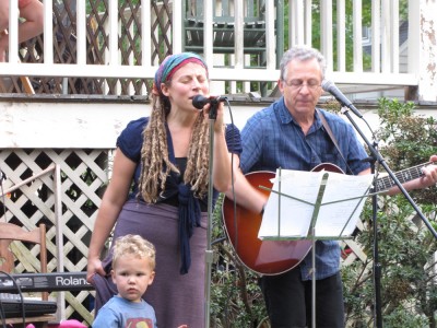 Leah and Grandpa Ira performing on stage, with Lijah alongside