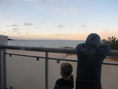 Harvey and Lijah on the hotel balcony watching the morning