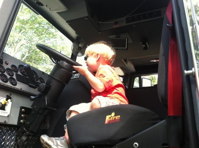 Zion sitting way up high in the driver's seat of the ladder truck