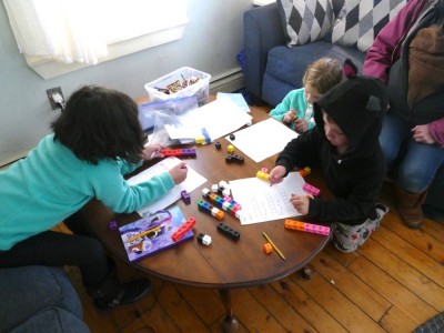 Lijah and two friends doing math work in our living room