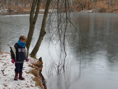 Lijah looking at a partially frozen pond
