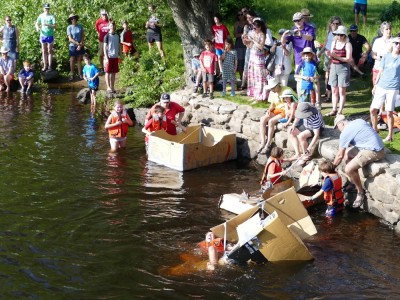 young people launching and sinking cardboard boats