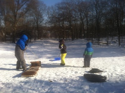 the boys at the top of a sledding hill