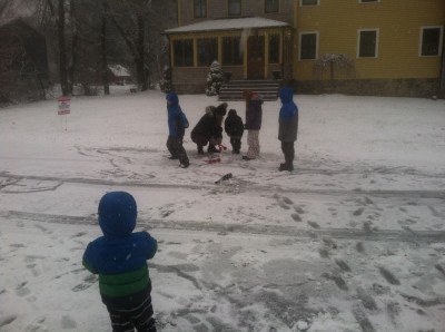 playing in the snow in front of the house