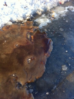 brown sludge from the landfill frozen on the bike path