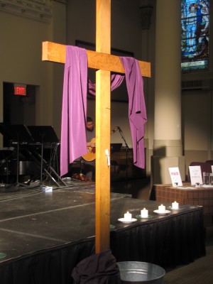the wooden cross at the front of the church, draped with purple
