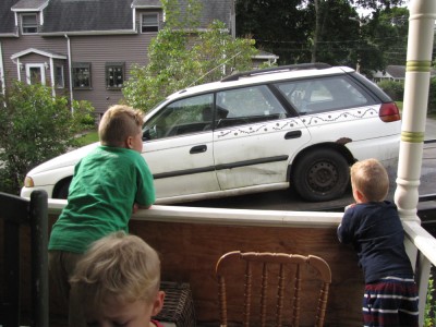 the boys watching the white car get towed away