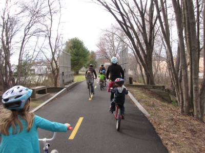 kids and grownups riding on the bike path