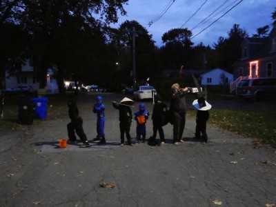 the boys and friends posing in the street before trick-or-treating