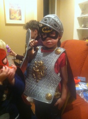 Zion wearing Hanukah presents: knight armor and batman mask