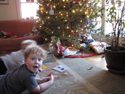 Harvey and Zion by our tree playing with their presents; Harvey looking excited