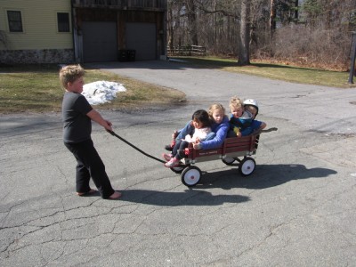 Harvey pulling four kids in the wagon