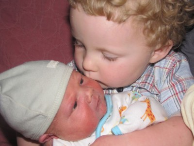 harvey kisses his baby brother