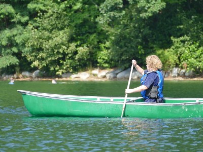 Harvey paddling the canoe on the lake