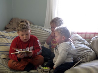 Harvey reading to his brothers on the couch