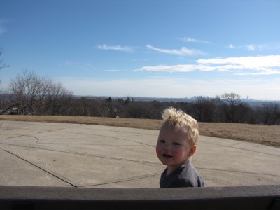 Lijah sitting on a bench at the top of Arlington Heights
