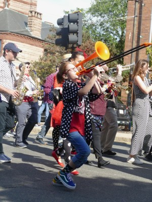a young female trombone player rockin out in the parade