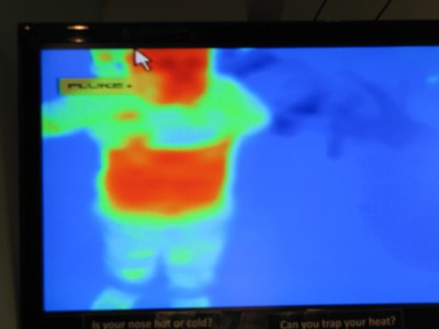 Harvey on the heat camera screen lifting his shirt to show his red belly