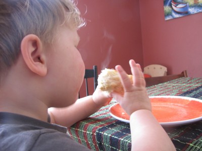 Lijah blowing on a steaming biscuit