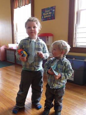 Harvey and Zion in the kids church classroom wearing matching outfits, ties, and seed pearl necklaces