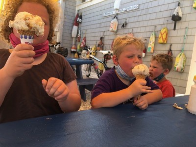 the boys, red-faced with sun, eating ice cream