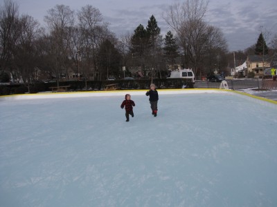Harvey and Zion running on the outdoor ice rink