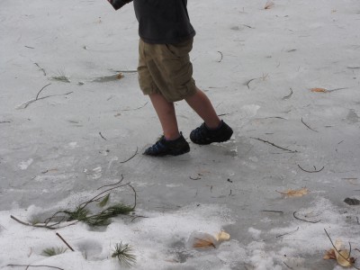 Zion on the slushy ice in shorts and sandals