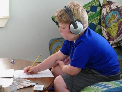 Harvey doing math work listening to music on the headphones