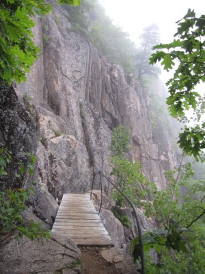 a wooden bridge and cliff face on the Precipice trail