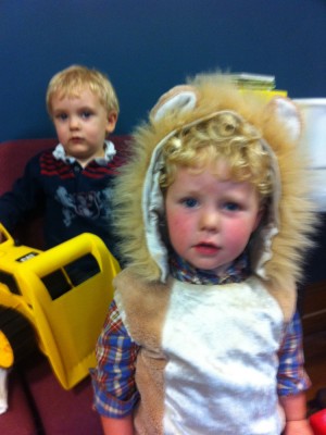Harvey in a lion costume with Ollie behind him
