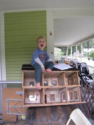 Lijah atop the doll house (itself up on a steamer trunk)