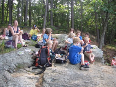 lots of kids picnicing on the rock above Fawn lake