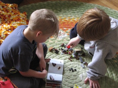 Zion and Nathan building legos on the schoolroom rug