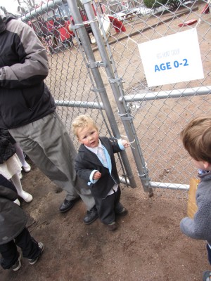 Lijah trying to squeeze through the gate into the egg hunt