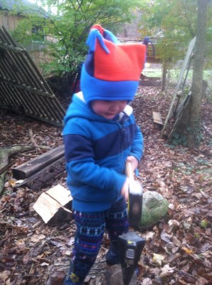 Lijah using the mallet and log wedge