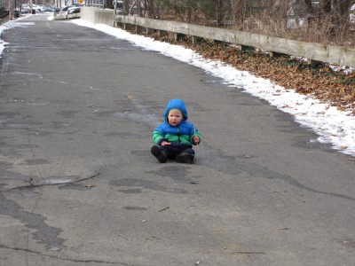 Lijah sitting down in the middle of the bike path