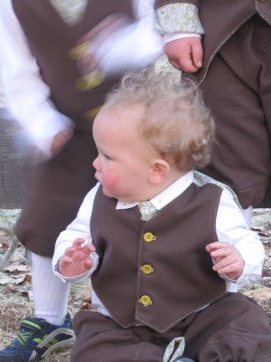 Lijah in his Easter suit, his brothers moving around behind him