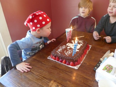 Lijah blowing out candles on his pirate cake