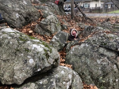 Elijah poking up from a hole in some rocks