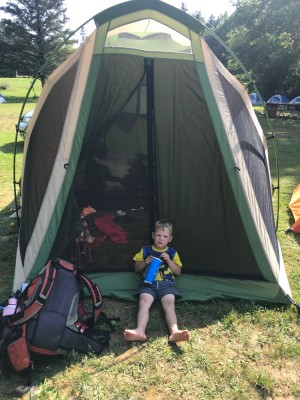 Lijah sitting in front of our tent looking tired