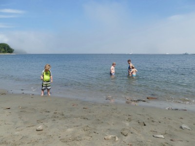 Mama and the boys in the water at the beach