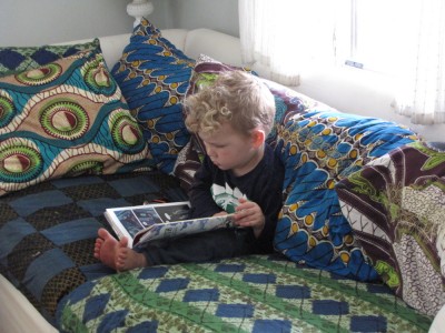 Lijah reading a book on the couch