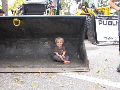 Zion sitting in the bucket of a front-end loader