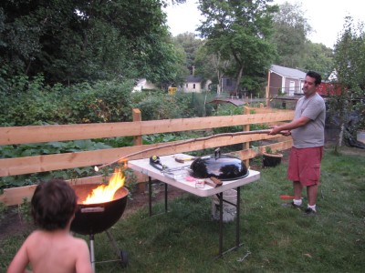 Samuel toasting a marshmallow on an 8-foot stick