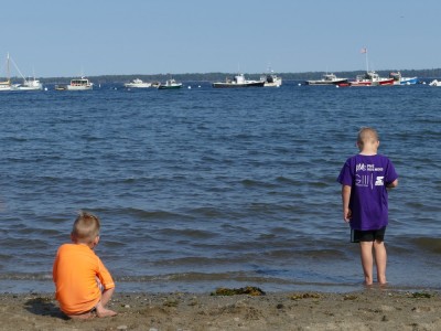 Zion and Lijah considering the water at the beach in Lincolnville