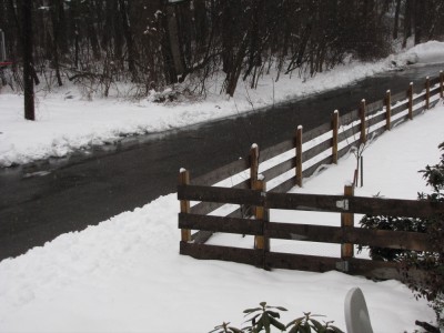 the fence standing up from wet snow