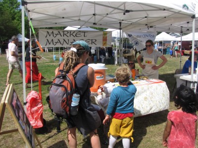 the family at the market manager's stall on opening day