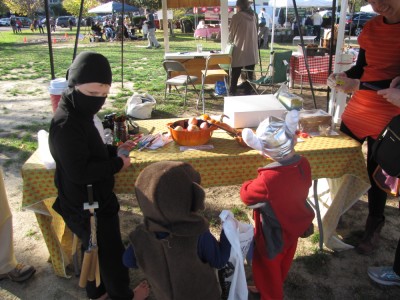 costumed boys trick-or-treating at the farmers market
